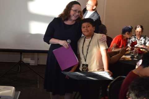 Stephanie Evans presents a $500 scholarship to Uriel Matias Salazar