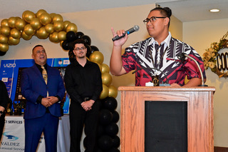 Ionatana Asu speaking at the podium, with Aaron Valdez and tutor Toni Atieh